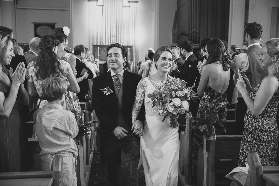 Jersey wedding photography - bride and groom exit the church