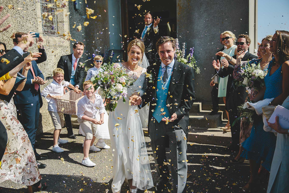 Jersey wedding photography. A confetti throw outside Gouray church.