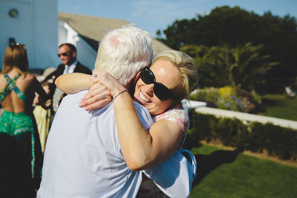 Wedding guests hugging at a wedding in Jersey, Channel Islands