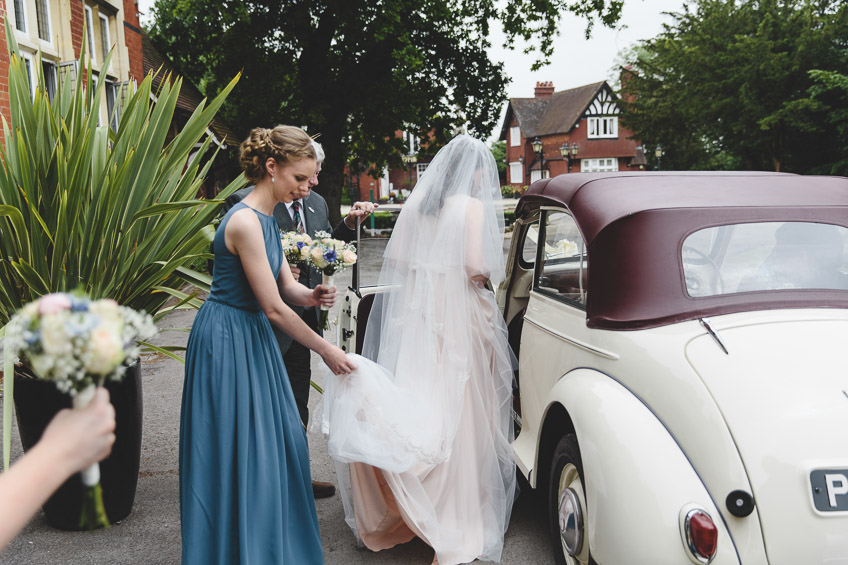 bride getting into wedding car