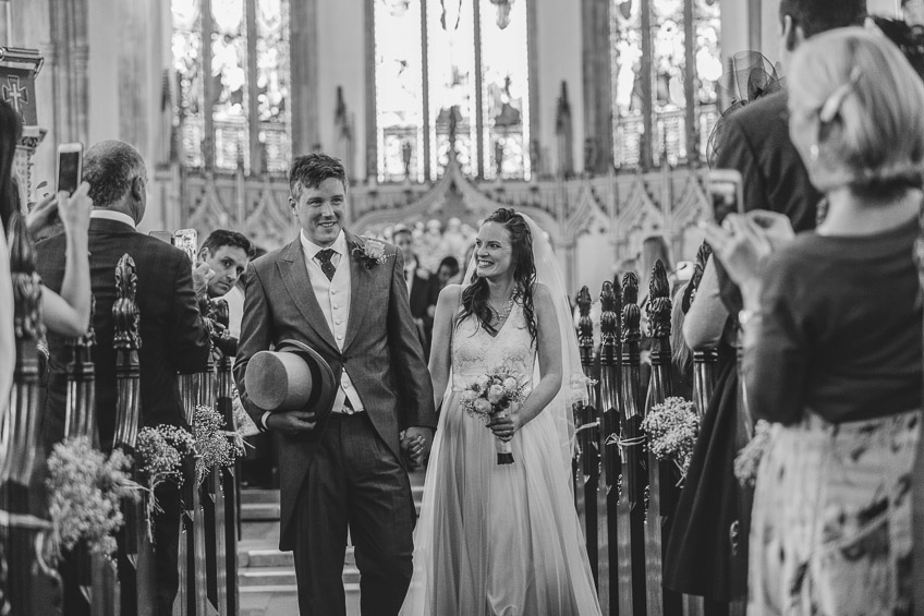 bride and groom walk down aisle