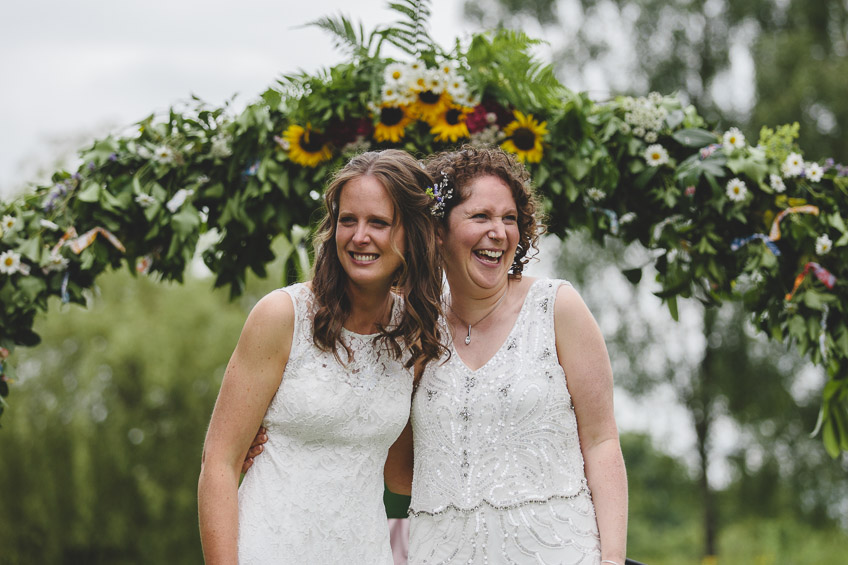 Brides laughing at end of ceremony