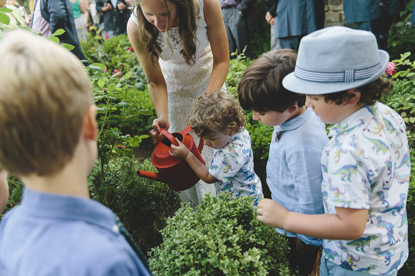 children watering plant